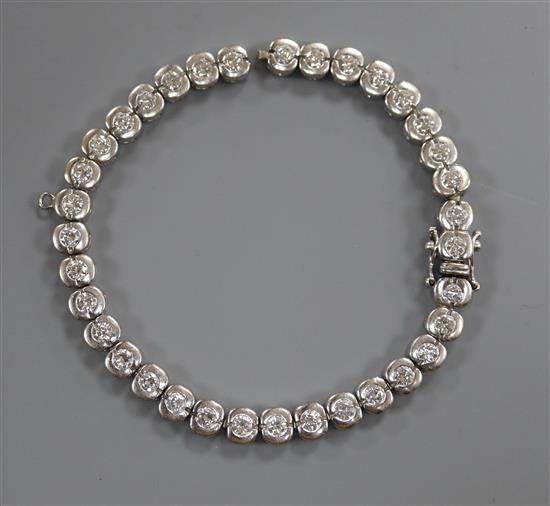 A modern 750 white metal and diamond set tennis bracelet (a.f.), 17.5cm.